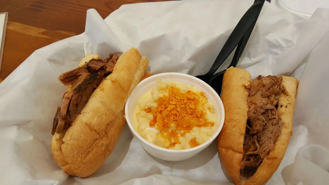 Two half sandos. One brisket, the other pulled pork. In the middle is their mac 'n cheese.
