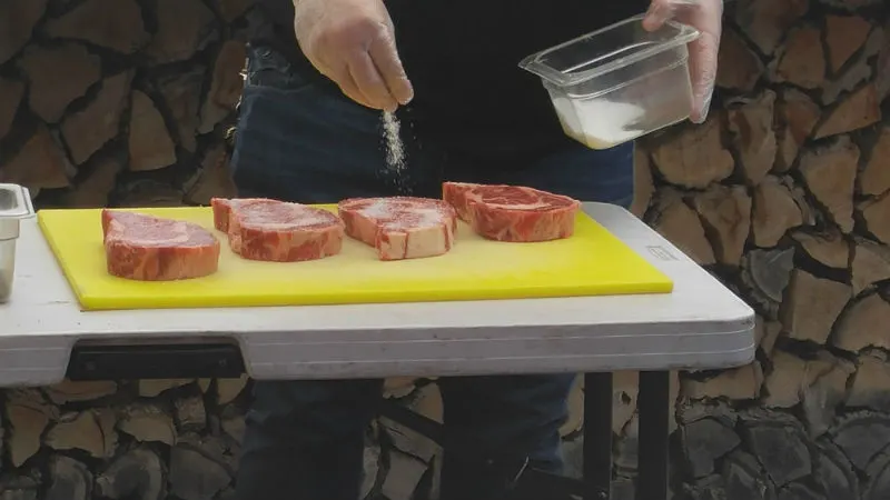 Salting the rib eyes